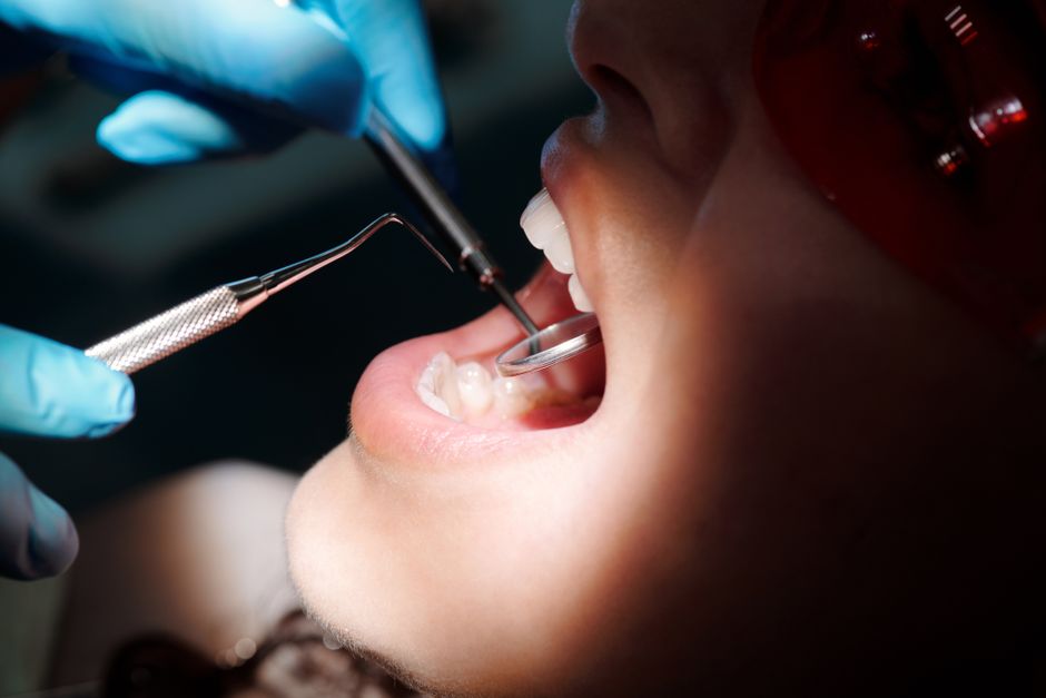 What happens during an oral cancer screening at the dental clinic?